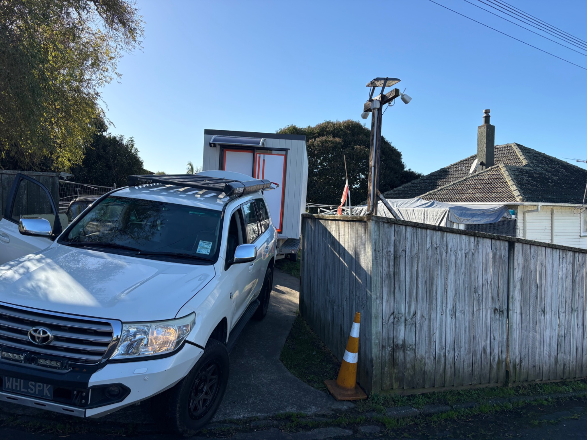 Land Cruiser towing a portable cabin for delivery