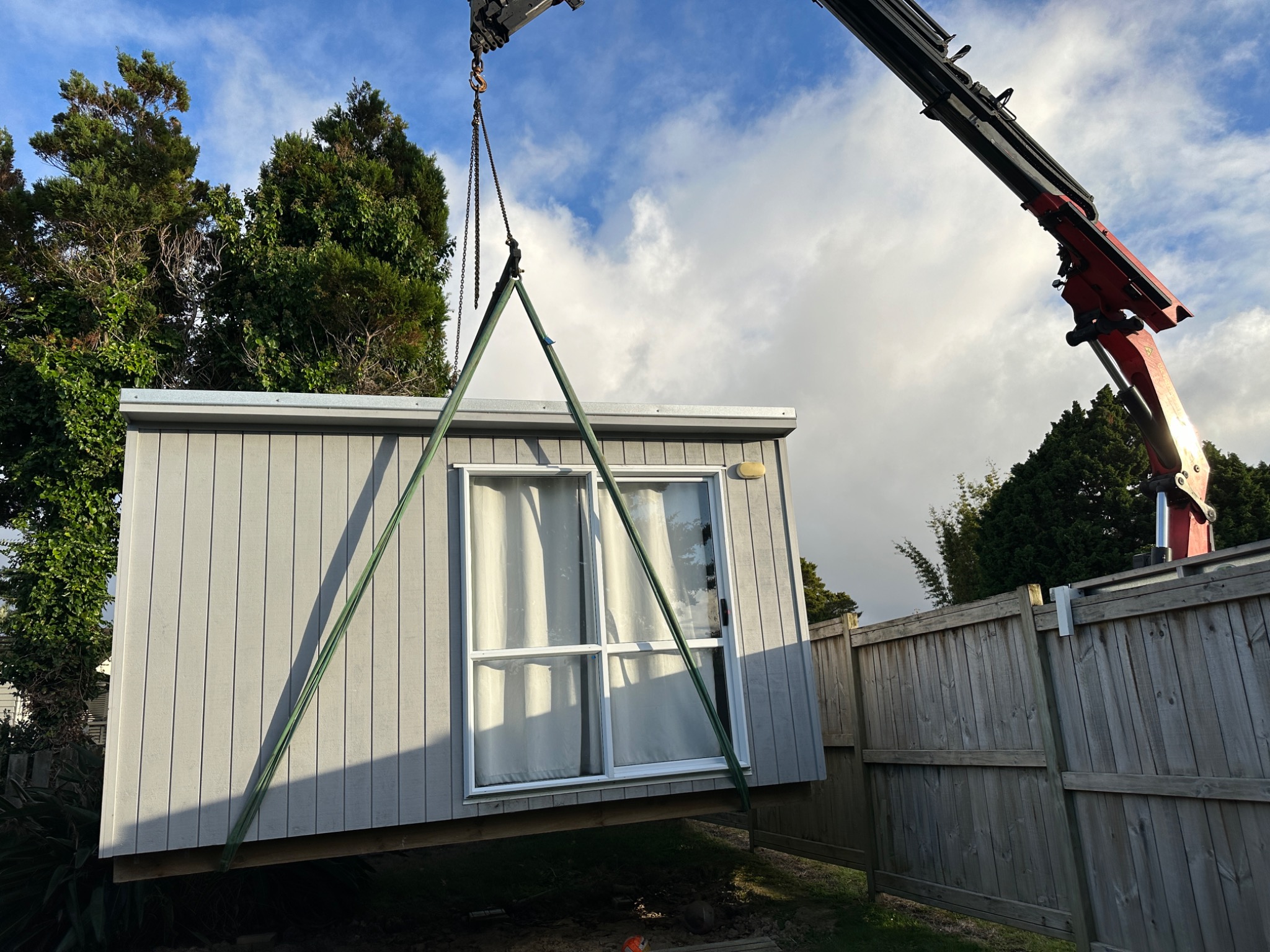 Crane placing a cabin on site